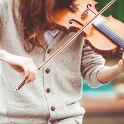 woman-in-gray-cardigan-playing-a-violin-during-daytime-111287.jpg